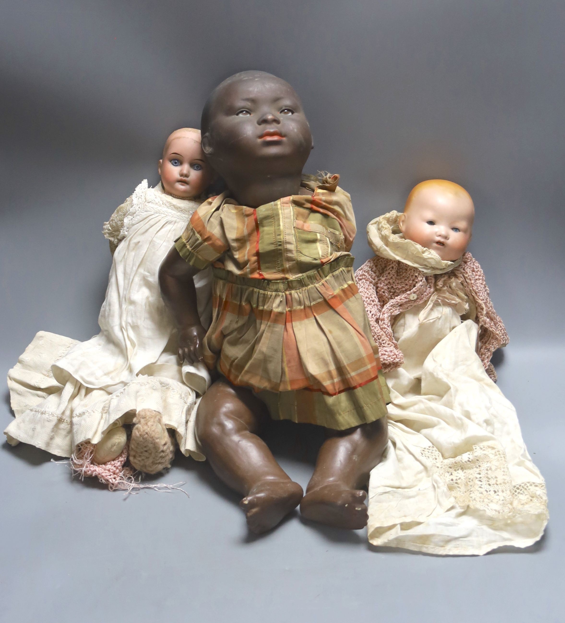 A black bisque-headed doll, German KB-M 5 bent limb with a smaller German bisque open mouth kid leather body doll and an AM Dream baby 351 with open mouth